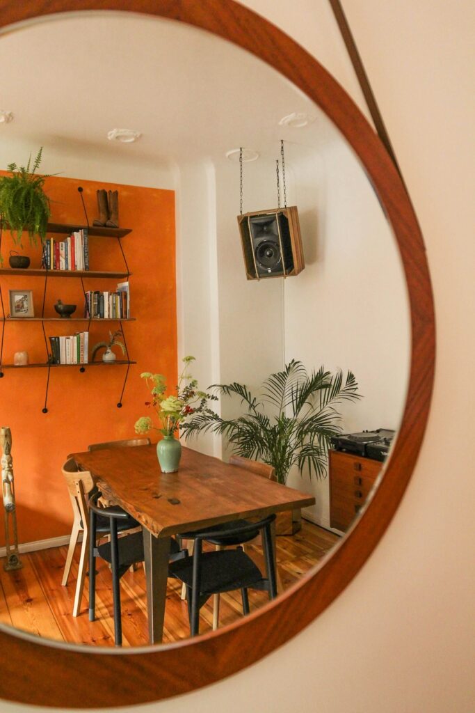Salle à manger chaleureuse avec table en bois et mur coloré, choix décoratifs assumés